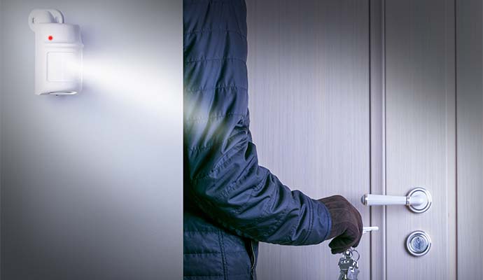 burglar breaking into a victim's home door